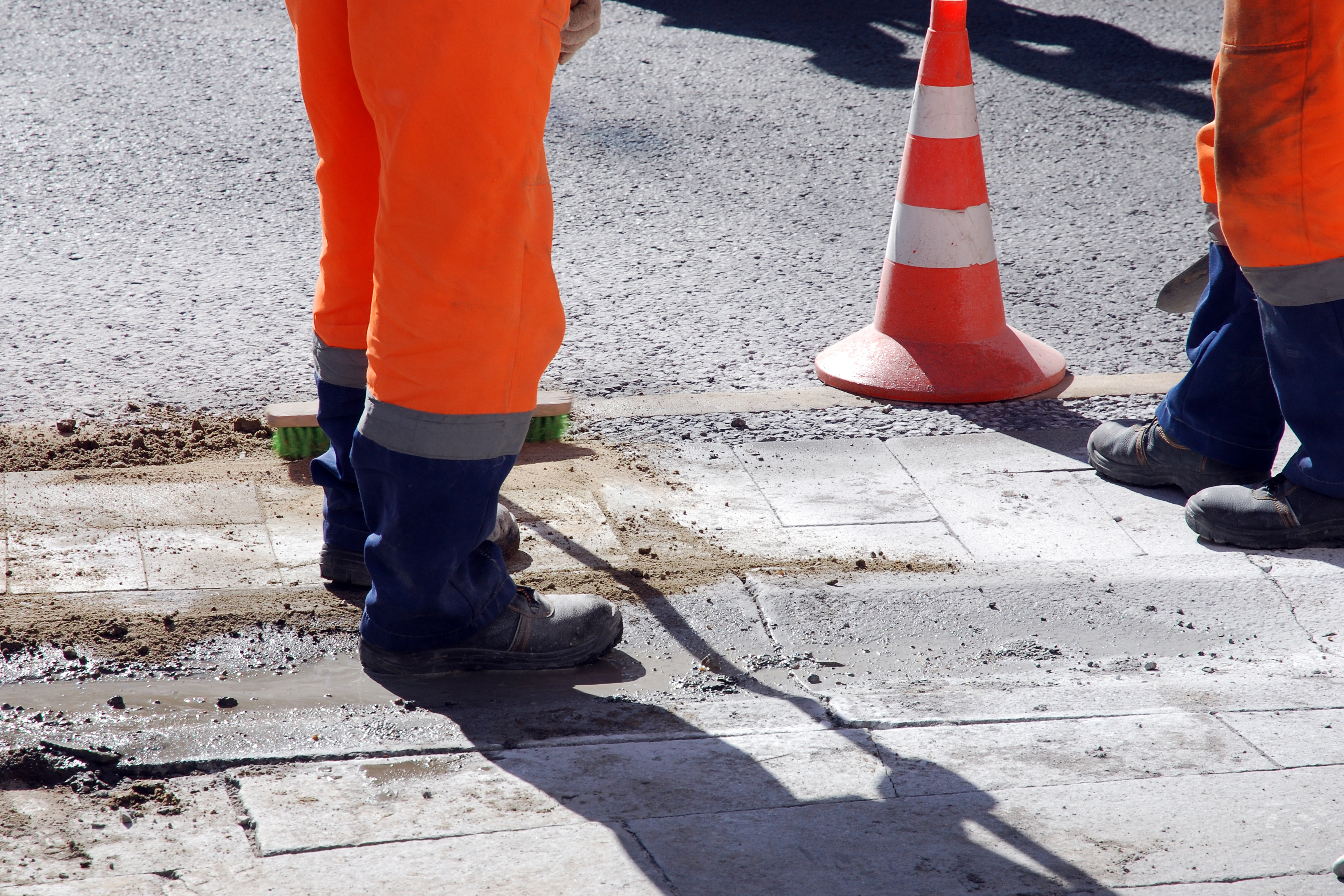 two construction workers on a footpath