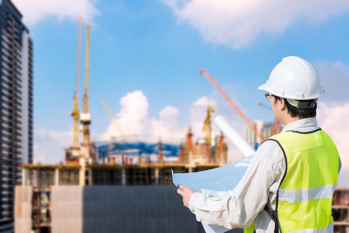 Photo of a construction worker looking at a site plan